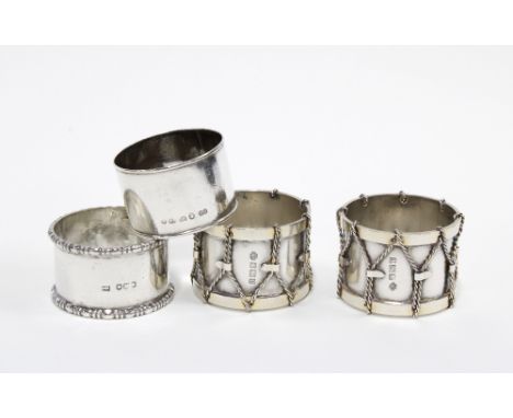 A pair of Edwardian silver 'drum' napkin rings, William Hutton, Sheffield 1907 and two other silver napkin rings (4)