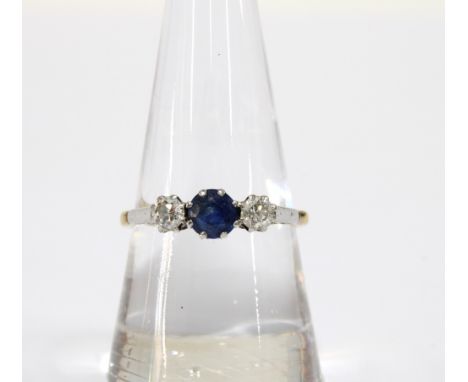 A sapphire and diamond three stone ring set in a white metal setting and unmarked yellow metal and 