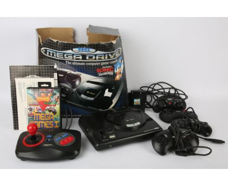 Sega Mega Drive Console Boxed + Extras. This lot contains a Sega Mega Drive (first model/PAL/white power & reset button) with
