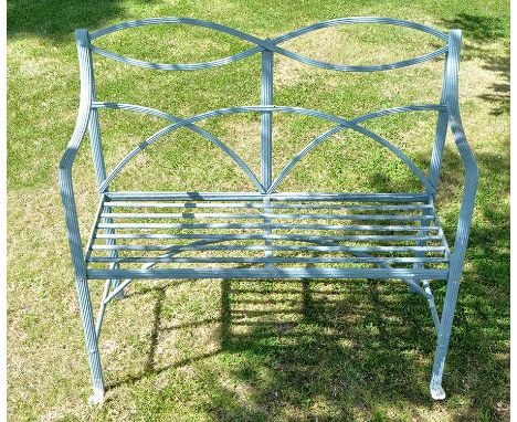 A cast iron two-seat garden bench, with reeded back, arms and seat, 42 x 15 x 39in. high.