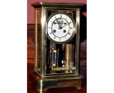 A brass four glass mantel clock, late 19th/early 20th Century, the enamelled roman dial with two train drum movement striking