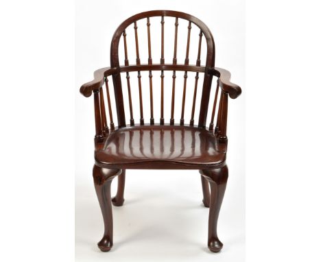 An early 20th Century mahogany elbow chair, by Jas. Schoolbred & Co., Tottenham Court Road, London West, the arched cresting 