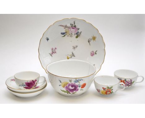 Meissen shallow bowl, painted with floral bursts, diameter 23.3cms, underglaze blue crossed swords mark; three cups and two s