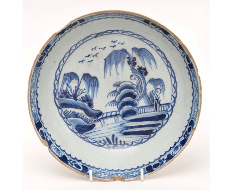 Delftware blue and white shallow bowl, the centre painted with chinoiserie landscape having weeping willows, 18th Century, di
