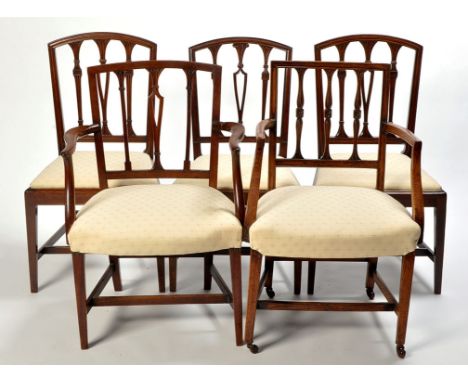 A set of six George III mahogany dining chairs, each with curved cresting rail above stick back, drop-in seat upholstered in 