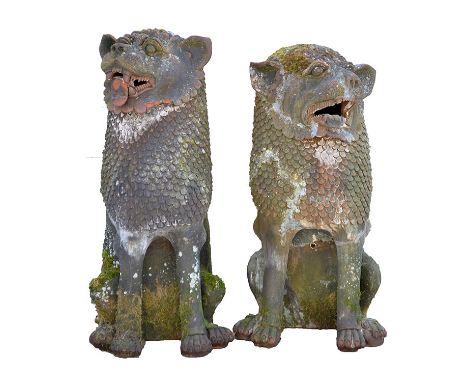 Two Chinese terracotta dogs of foe garden ornaments, each with open mouths and scale manes, the larger 41in. high. 