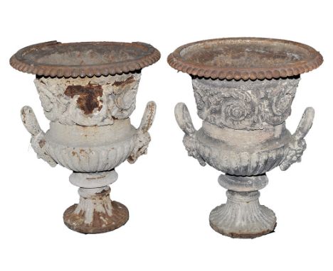 A pair of 19th Century cast iron half-fluted campana form garden urns, each with beaded rim above floral scrolls and mask pat