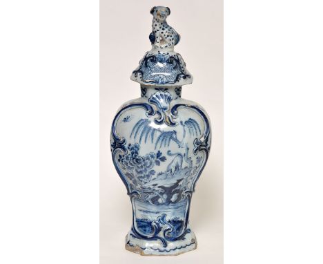 Delftware blue and white vase and cover, inverted baluster form painted with hound or fox standing on ledge above water's edg