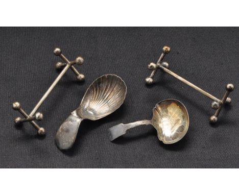 A pair of George III knife rests, by Phipps & Robinson, London 1808; and two Georgian/Victorian caddy spoons (damaged).  (4)