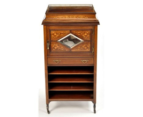 An Edwardian inlaid rosewood pedestal cabinet, the caddy top with three-quarter brass balustrade above central floral scrolli