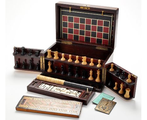 An early 20th Century games compendium, the stained walnut box containing chess, draughts, dominoes, cribbage and steeplechas