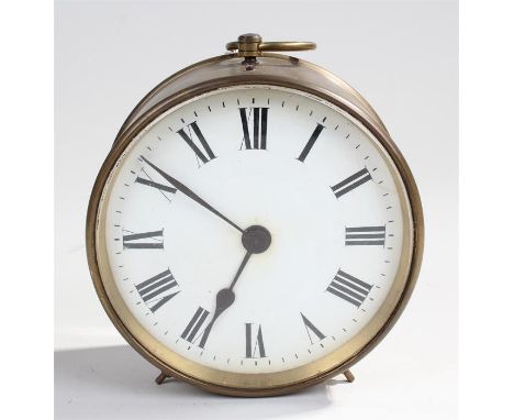 Circular brass French mantle clock, white enamel dial with Roman hour markers, key present, 13.5 cm in diameter