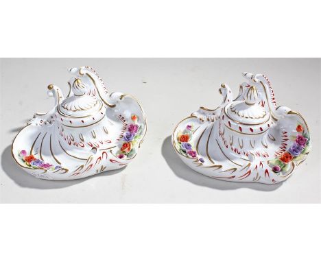 Pair of porcelain inkwells, the finial top inkwells with folate scroll base, (2)