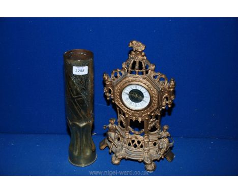 A brass clock and shell.