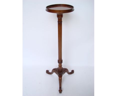 A 20th Century mahogany torchere stand, the galleries platform top on fluted stem and tripod base with scroll feet, 110cm hig