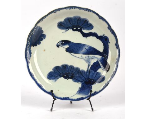 An Arita sometsuke dish, decorated with a bird of prey perched on pine, 25.5 cm diameter, with five spur marks on the base; t