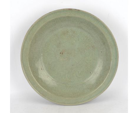 A heavily potted celadon dish with crackle design, probably intended for the South-East Asian Market; with an unglazed area o