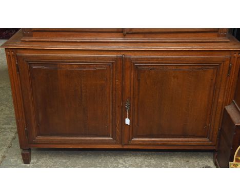 A Louis XVI style oak cabinet, 1900s, the pair of panelled doors enclosing a shelf, on short tapered feet, H 91cm, W 151cm, D