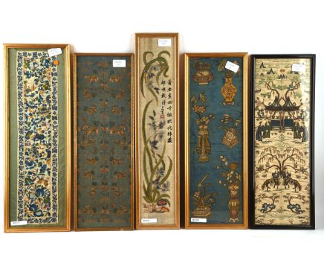 A Chinese textile sleeve band, framed and glazed, decorated with an elegant floral design beside a two-line inscription and r