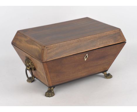 A Regency mahogany work box of sarcophagus form, the hinged lid opening to reveal a fitted tray, flanked by lion ring brass h