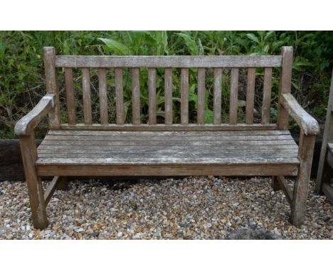 A wooden slatted garden bench, of palin design, 94cm high x 148cm wide x 64cm deep