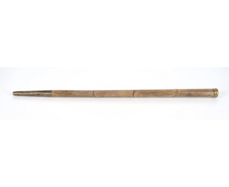A late 19th century, novelty telescope walking stick.  The brass cap enclosing a compass, the faux bamboo body enclosing a si