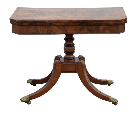 A Regency mahogany card table, circa 1815, with ebony details, the flame veneered swivel top with canted corners, the turned 