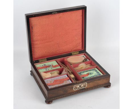 A quantity of Japanese mother of pearl gaming chips contained in a late 19th century, bone inlaid rosewood box with compartme