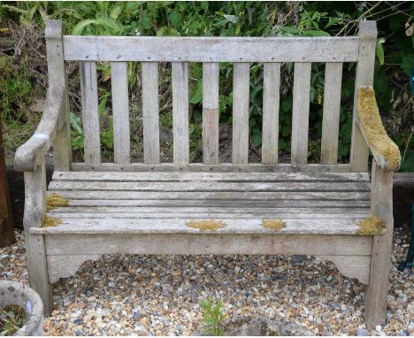 A wooden garden bench, of slatted design, 20th Century, 95cm high x 121.5cm wide x 62cm deep