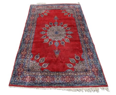 A Persian wool rug, with central lantern hung medallion and leaf hung spandrels, on red ground,  L 224cm, W 137cm