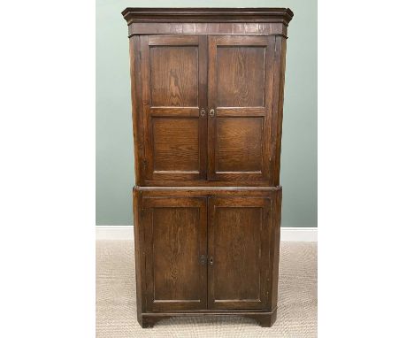 ANTIQUE OAK TWO-PIECE FLOORSTANDING CORNER CUPBOARD, having twin two-panel upper doors with interior shelving, reeded central