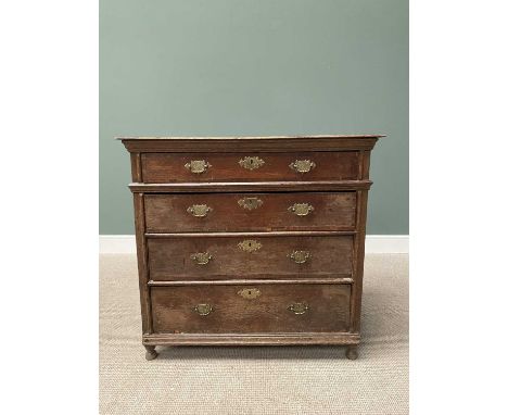 GEORGIAN OAK CHEST of four long crossbanded oak lined drawers, with later brassware, panel sided on block and turned supports