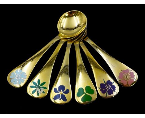 Six Danish silver-gilt year spoons by Georg Jensen, each decorated with different floral motif including violet and shamrock,