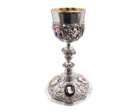 German silver chalice, the bowl, stem and foot each with 19th century repousse and chased decoration depicting putti masks, C