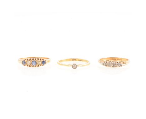 Three diamond set rings, a diamond solitaire with a small old cut diamond millegrain set in a yellow and white metal mount ma