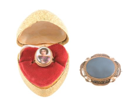 A Victorian mourning brooch with central oval agate and enamel border, engraved on reverse with the dates 1879, 1883, locket 