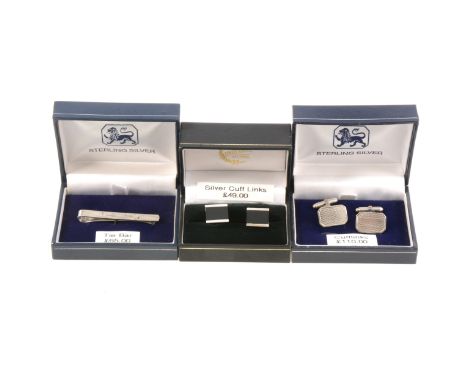 Two pairs of silver cufflinks, a rectangular engine turned pair with torpedo backs, a pair set with black onyx, hinged backs,