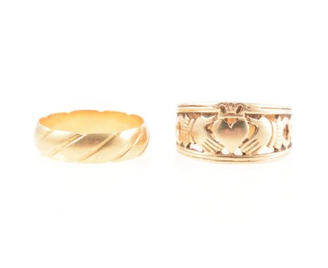An 18 carat yellow gold wedding band, 5.7mm wide D shape with slanted line decoration, London 1988, ring size R, 4.6g, a 9 ca