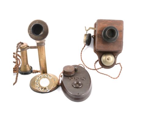 Three early 20th-century telephones, including brass Candlestick telephone; and two wall telephone.