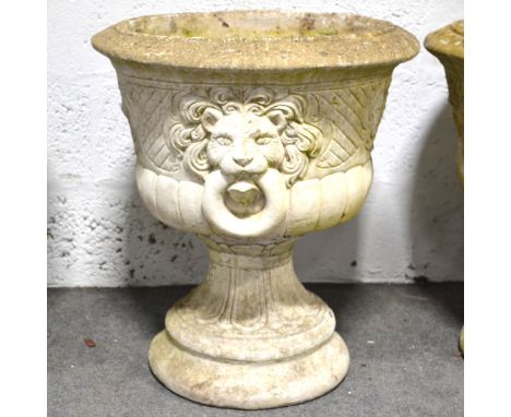 Pair of modern stone pedestal planters, circular bowls with cast baskets of flowers and lion ring masks, tapering column, dia