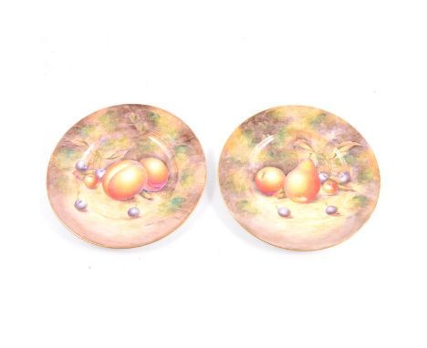 Pair of Royal Worcester cabinet plates, painted with fruit, by Sibley Lewis, 20cm diameter.