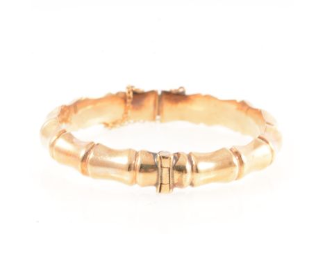 A 9 carat yellow gold bamboo design half hinged bangle, 9mm wide, Birmingham 1963, 15.2g.