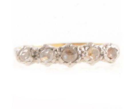 A diamond half hoop ring, the rose cut stones graduating in size slightly illusion set in a yellow and white metal mount, sha
