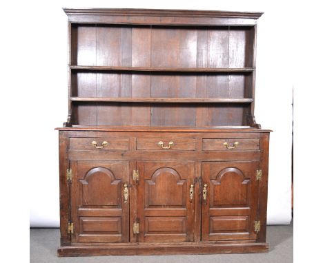 An oak and elm dresser, 19th century, the raised back with two shelves, above rectangular top, three short drawers and three 