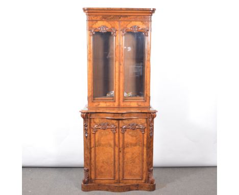 Victorian figured walnut bookcase cabinet, moulded cornice, the upper section with two glazed doors enclosing three adjustabl