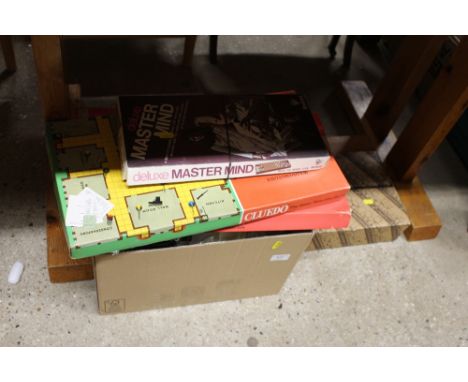 A box containing board games, textiles, various plates, boxed glassware etc. 