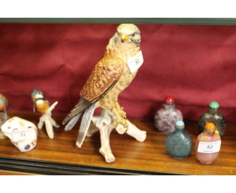 A Goebel model bird on branch 