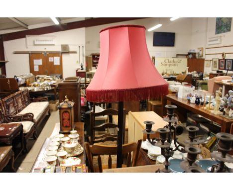A mahogany standard lamp and shade 
