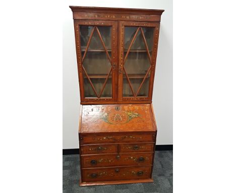 A Sheraton and later satinwood veneered bureau book case,  with astral glazed doors (with replaced batons) having a fitted sh