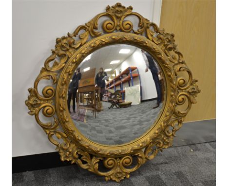 A giltwood circular convex wall mirror,  with foliate design frame, diameter 85cm, together with a convex wall mirror with ba